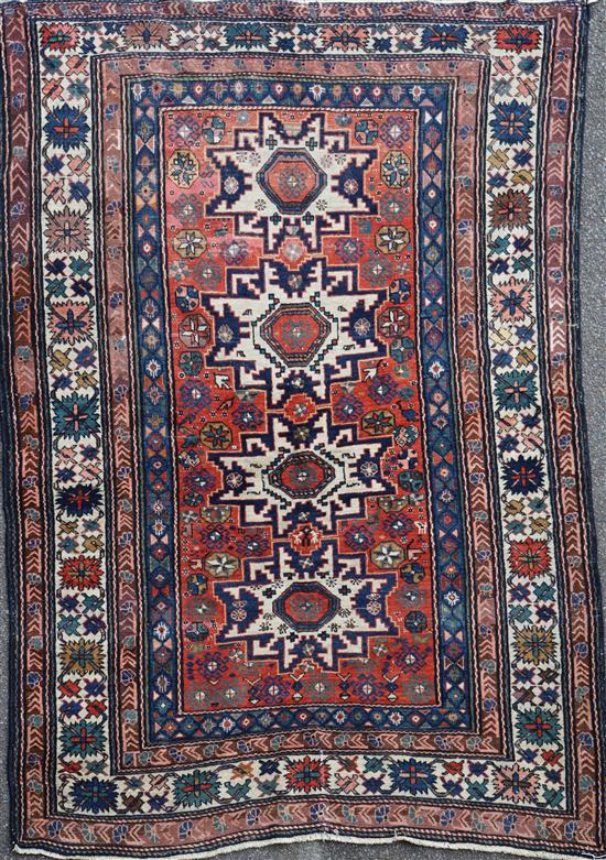 A Caucasian red ground rug, 6ft 10in by 5ft 3in